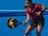 Woman in CRIVIT sportswear playing padel on a blue court