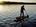 Erik Sander auf seinem Crivit Stand-Up-Paddle-Board bei Sonnenuntergang auf einem See.