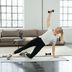 Fitness expert Linda performs a side‑support exercise with a CRIVIT dumbbell in a bright living room.