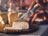 Cutting creamy cheese with a SILVERCREST kitchen knife on a wooden board.