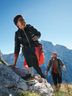 A man and a woman wearing CRIVIT sportswear hiking against a mountain backdrop