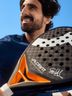 Close-up of a padel player holding a CRIVIT Stefanie Graf Limited Edition Padel Racket 12K Carbon PRO in their hand.