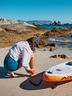 Image Young man using a stand up paddle board