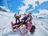 Two children in CRIVIT winter gear sledging on a snowy slope watched by a man