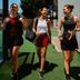 Agostina Bigotti and two friends in CRIVIT sportswear walking and laughing out of a padel court with padel racket bags.