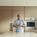 Andre Agassi standing and smiling in a modern kitchen.