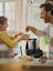 Adult and child baking together at a kitchen counter, adding blueberries while the SILVERCREST Monsieur Cuisine sits nearby.