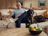 Andre Agassi relaxing on a sofa with a dog and a cat in a cozy living room, styled with SILVERCREST products and a coffee table in the foreground.