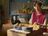 Woman preparing ingredients at a kitchen table with the SILVERCREST Monsieur Cuisine on the counter nearby.