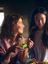 Two women enjoying a warm moment together as one pours hot water from a SILVERCREST electric kettle into the other’s glass filled with fresh mint and lime.