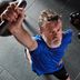 Man training with CRIVIT fitness equipment in a gym.