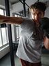 Man in CRIVIT boxing gloves punching a bag in a gym
