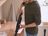 Man cleaning kitchen counter with a SILVERCREST handheld vacuum cleaner.