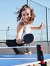 Woman wearing CRIVIT sportswear playing table tennis