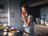 Person cooking in a modern kitchen using SILVERCREST cookware, tasting food while preparing a meal.