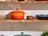 Colorful SILVERCREST casserole dishes and cookware displayed on wooden kitchen shelves.