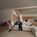 Andre Agassi using a SILVERCREST cordless vacuum cleaner at home.