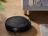 SILVERCREST robot vacuum cleaning a wooden floor.